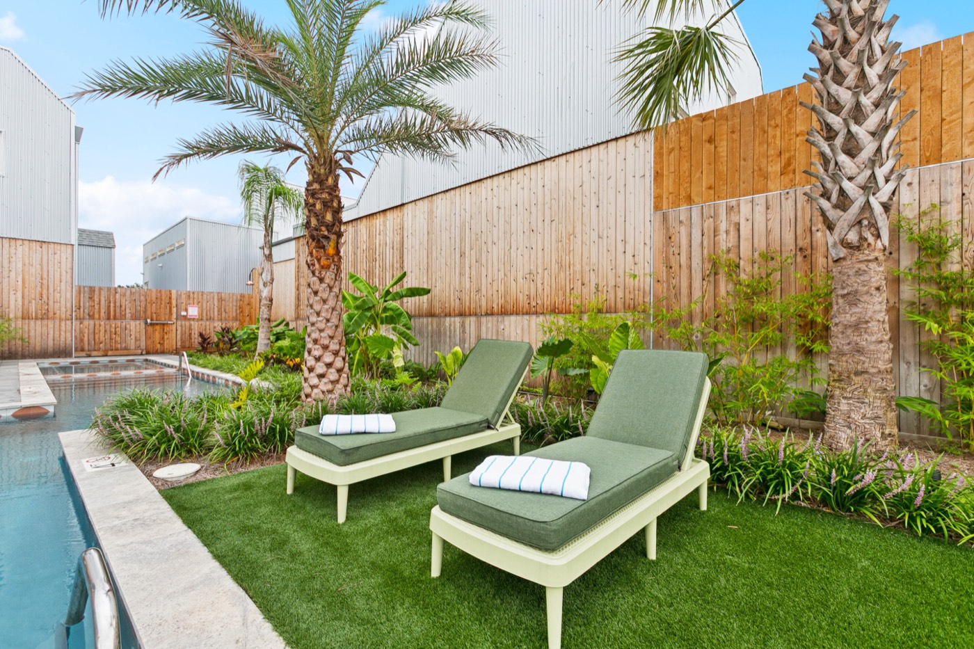 Private pool with palm trees and loungers at a New Orleans group villa