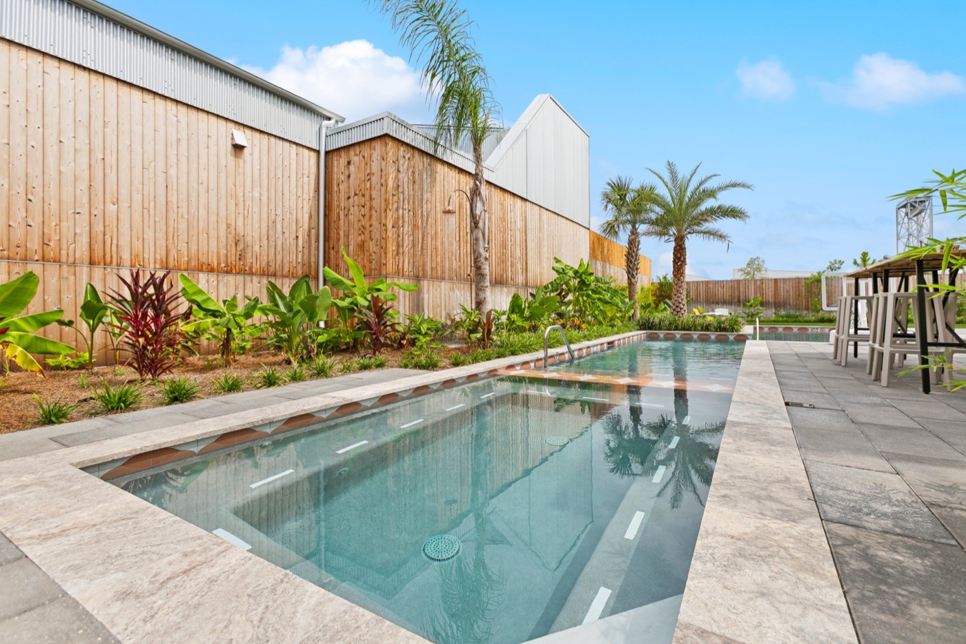 Quiet heated pool surrounded by tropical landscaping